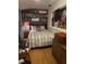 Cozy bedroom with wood flooring, decorative shelves, and a vintage record player at 6015 19Th N St # 308, St Petersburg, FL 33714