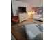 Open living room featuring a sofa, colorful artwork, entertainment center, and contemporary chair on wood floors at 6015 19Th N St # 308, St Petersburg, FL 33714