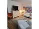 Living room featuring a modern dresser with TV, colorful artwork, and stylish seating on a patterned rug at 6015 19Th N St # 308, St Petersburg, FL 33714