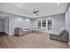 Spacious living room featuring a sectional sofa, tile flooring and french doors at 6070 Denver Ne St, St Petersburg, FL 33703