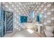 Unique bathroom with distinctive tile design, modern fixtures, and a glass shower at 516 Belle Isle Ave, Belleair Beach, FL 33786
