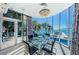 Modern dining room with ocean view, pool access, and a glass dining table at 516 Belle Isle Ave, Belleair Beach, FL 33786