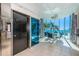 Sunlit dining area with ocean views, a modern chandelier, and access to an elevator at 516 Belle Isle Ave, Belleair Beach, FL 33786