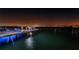 Nighttime view of private dock with outdoor seating, stylish lighting, and serene water views at 516 Belle Isle Ave, Belleair Beach, FL 33786