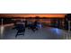 Waterfront home featuring a dock with outdoor seating and stunning sunset views at 516 Belle Isle Ave, Belleair Beach, FL 33786