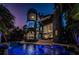 Elegant waterfront home with a dazzling pool, spa, and illuminated glass tower at 516 Belle Isle Ave, Belleair Beach, FL 33786