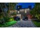 Modern brick home featuring a patterned driveway with an SUV and golf cart parked in front at 516 Belle Isle Ave, Belleair Beach, FL 33786