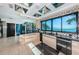 Open kitchen with black countertops, sleek cabinetry, stainless steel appliances, and views of the intercoastal at 516 Belle Isle Ave, Belleair Beach, FL 33786