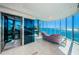 Bright living room with floor-to-ceiling windows and panoramic water views at 516 Belle Isle Ave, Belleair Beach, FL 33786