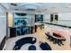 Spacious living area with water views, modern decor, statement chandelier, and access to an upstairs mezzanine at 516 Belle Isle Ave, Belleair Beach, FL 33786
