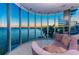 Panoramic views enhance this living room with large windows and cozy seating at 516 Belle Isle Ave, Belleair Beach, FL 33786
