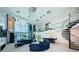 Expansive living area with soaring ceilings, spiral staircase, wet bar and floor to ceiling windows at 516 Belle Isle Ave, Belleair Beach, FL 33786