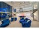 Elegant living space with a spiral staircase, wet bar, and comfortable blue lounge seating at 516 Belle Isle Ave, Belleair Beach, FL 33786