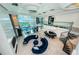 Open floor plan with a large living room featuring a winding staircase and bar area at 516 Belle Isle Ave, Belleair Beach, FL 33786