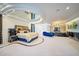 Large main bedroom featuring unique tray ceilings, jacuzzi tub, and a blue chaise lounge at 516 Belle Isle Ave, Belleair Beach, FL 33786