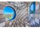 Unique tiled shower featuring distinctive design, modern fixtures and a porthole window at 516 Belle Isle Ave, Belleair Beach, FL 33786