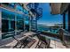 Outdoor patio area with spiral staircase, lounge seating, and expansive water views at 516 Belle Isle Ave, Belleair Beach, FL 33786