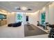 Spacious workout room with weightlifting equipment, a large TV, and natural light from the surrounding windows at 516 Belle Isle Ave, Belleair Beach, FL 33786