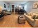 Living room with light wood floors, sofa, and kitchen view at 19930 Gulf Blvd # 1A, Indian Shores, FL 33785