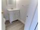 Simple bathroom, featuring white vanity and wood-look flooring at 5750 80Th N St # B208, St Petersburg, FL 33709