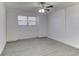 Bedroom with ceiling fan and grey flooring at 5750 80Th N St # B208, St Petersburg, FL 33709