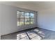 Living room with hardwood floors and a view from a large window at 5750 80Th N St # B208, St Petersburg, FL 33709