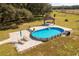 Aerial view of a large pool with a patio and gazebo at 3136 Neff Lake Rd, Brooksville, FL 34602