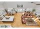 Open concept living and dining space with hardwood floors and island kitchen at 3136 Neff Lake Rd, Brooksville, FL 34602
