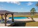 Expansive pool and patio with lake view at 3136 Neff Lake Rd, Brooksville, FL 34602