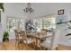 Bright dining room features a rustic wooden table, ample natural light, and views of the backyard at 3136 Neff Lake Rd, Brooksville, FL 34602