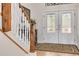 Bright entryway with hardwood floors, double doors, and staircase at 3136 Neff Lake Rd, Brooksville, FL 34602