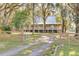 Elevated house with large porch and metal roof, long driveway at 3136 Neff Lake Rd, Brooksville, FL 34602