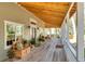 Spacious front porch with wooden flooring, rocking chairs, and plants at 3136 Neff Lake Rd, Brooksville, FL 34602