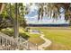 Landscaped backyard oasis with a pool, gazebo, and walking path at 3136 Neff Lake Rd, Brooksville, FL 34602