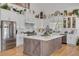 Modern kitchen boasts a large island, white cabinets, stainless steel appliances, and a farmhouse sink at 3136 Neff Lake Rd, Brooksville, FL 34602
