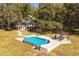 Aerial view of a luxurious pool and patio area next to the house at 3136 Neff Lake Rd, Brooksville, FL 34602