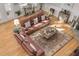 Sun-drenched living room with leather sofas, a coffee table, and hardwood floors at 3136 Neff Lake Rd, Brooksville, FL 34602
