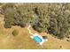 House nestled in trees with pool and gazebo visible at 3136 Neff Lake Rd, Brooksville, FL 34602