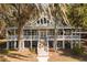 Two story home with large wrap around porch and beautiful landscaping at 3136 Neff Lake Rd, Brooksville, FL 34602