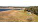Aerial view of property showing pool, lake and outbuildings at 3136 Neff Lake Rd, Brooksville, FL 34602