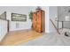 Light-filled upper hallway with hardwood floors and stylish wood cabinet at 3136 Neff Lake Rd, Brooksville, FL 34602