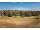 Aerial view of a house with a pool, surrounded by lush greenery at 3136 Neff Lake Rd, Brooksville, FL 34602