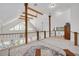 Open upper hallway with high ceilings, hardwood floors, and a view of the lower living space at 3136 Neff Lake Rd, Brooksville, FL 34602