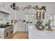 Open kitchen with white cabinets, large island, stainless steel appliances, and open shelving at 3136 Neff Lake Rd, Brooksville, FL 34602
