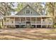 Two-story house with wraparound porch and large yard at 3136 Neff Lake Rd, Brooksville, FL 34602