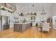 Modern kitchen with white cabinets, a large island, and stainless steel appliances at 3136 Neff Lake Rd, Brooksville, FL 34602
