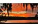 Dramatic sunset with fiery clouds reflected in a calm lake at 3136 Neff Lake Rd, Brooksville, FL 34602
