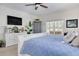 Main bedroom with a large bed, TV, and plenty of storage space at 3136 Neff Lake Rd, Brooksville, FL 34602