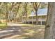 Elevated house with wrap around porch nestled among trees at 3136 Neff Lake Rd, Brooksville, FL 34602