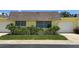Front view of a yellow house with attached garage and well-maintained lawn at 7057 Versailles N # 15, Pinellas Park, FL 33781